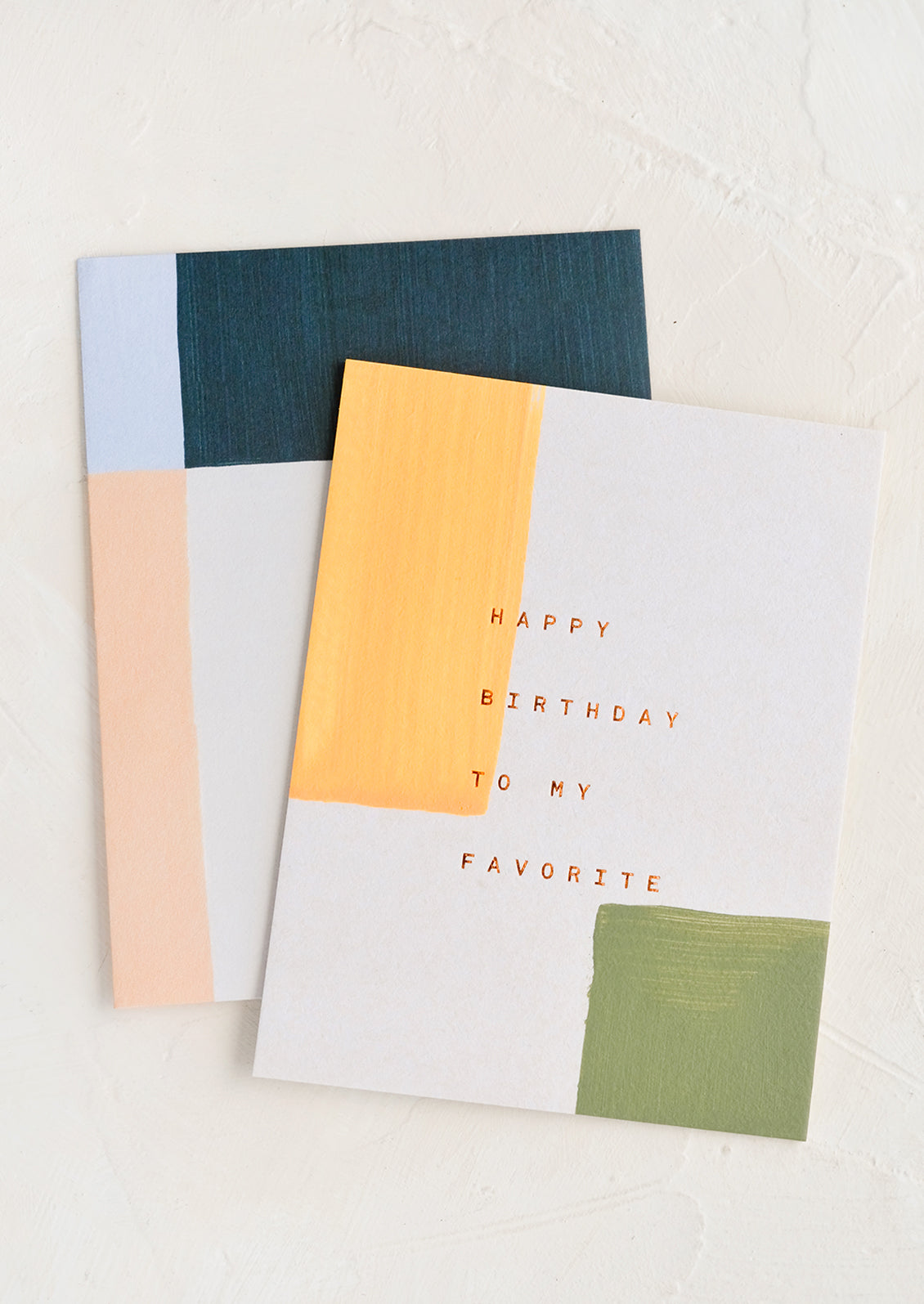 A birthday card with hand painted blocks and copper lettering reading "Happy Birthday To My Favorite".