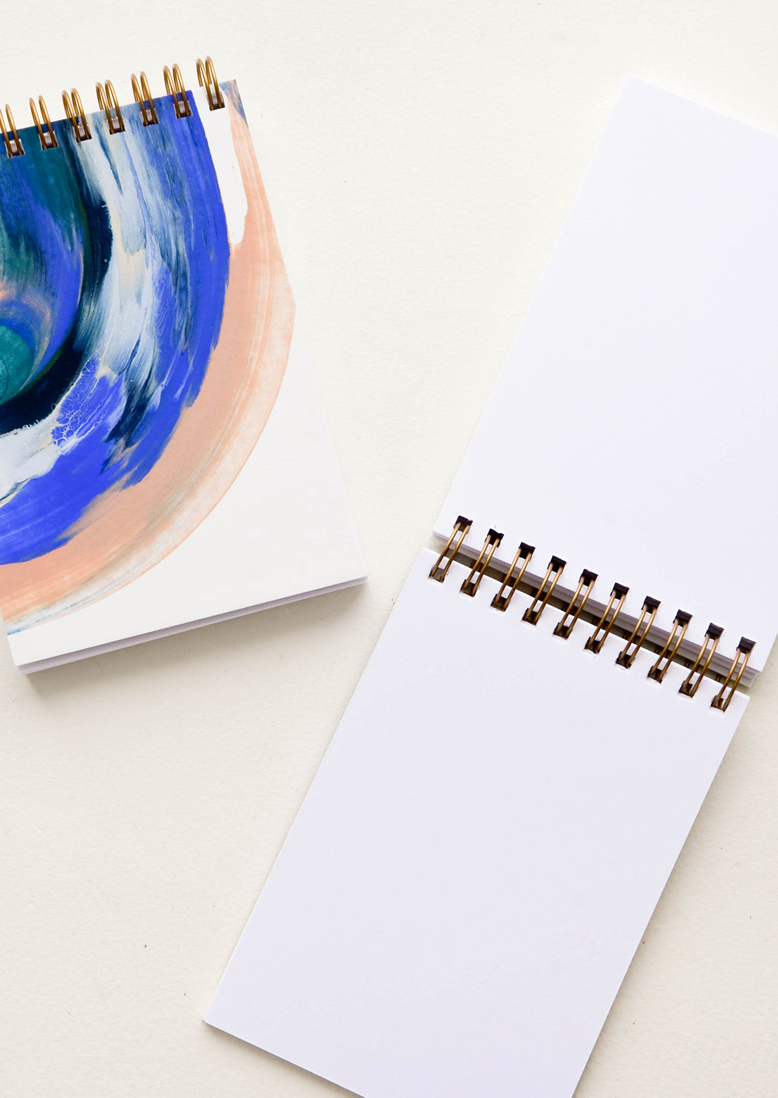 Spiral bound notebook with painted cover and blank unruled pages