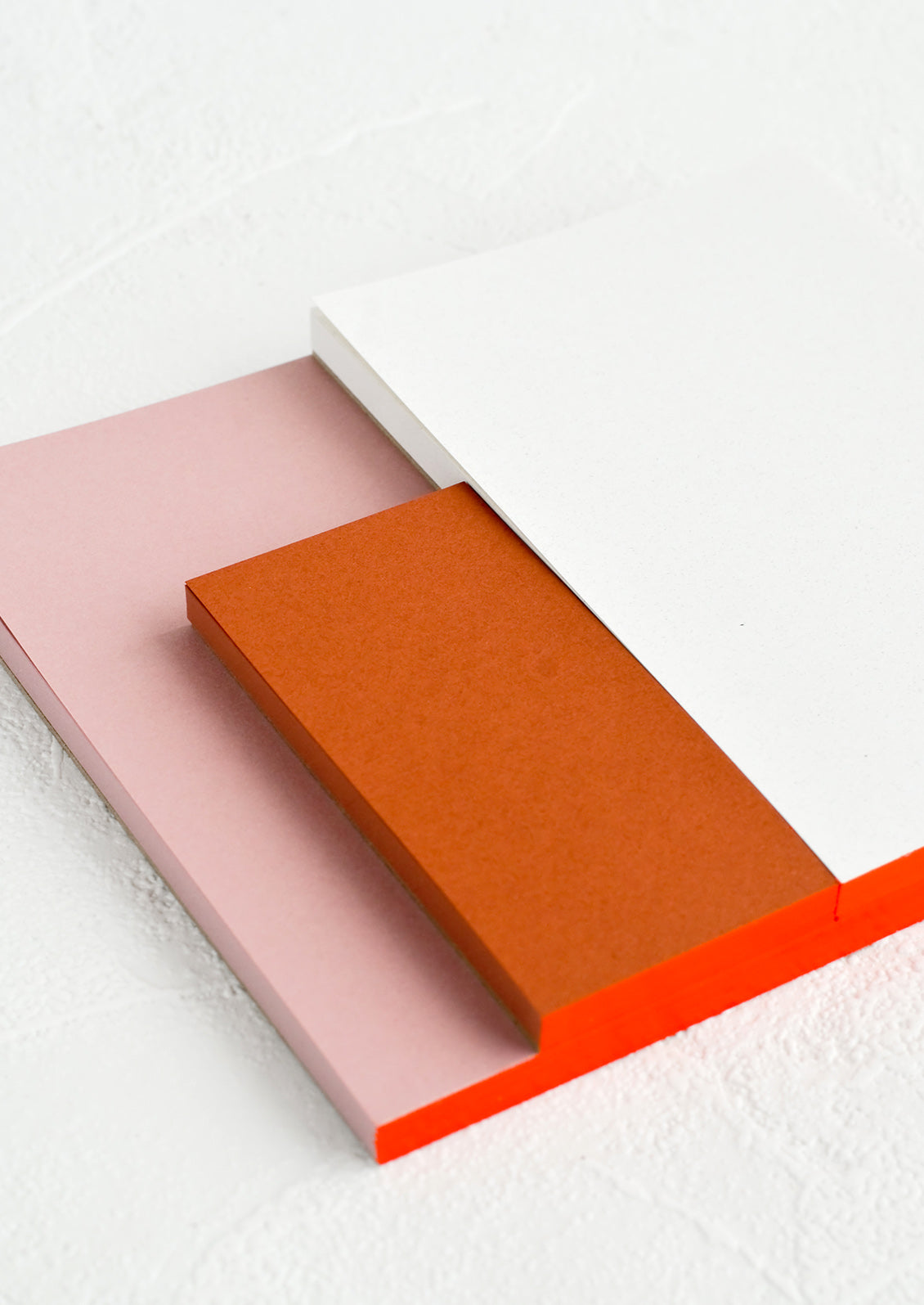A sectioned notepad with red binding.