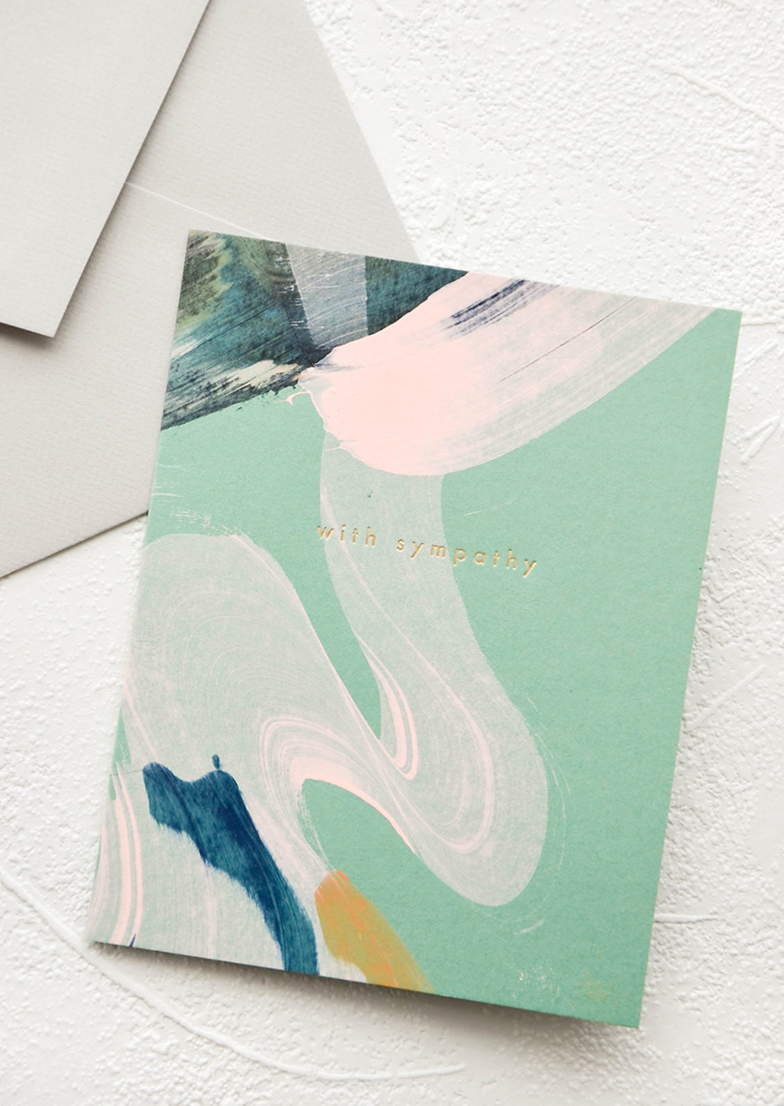 Greeting card with hand-painted pastel swirls, "with sympathy" printed in gold foil