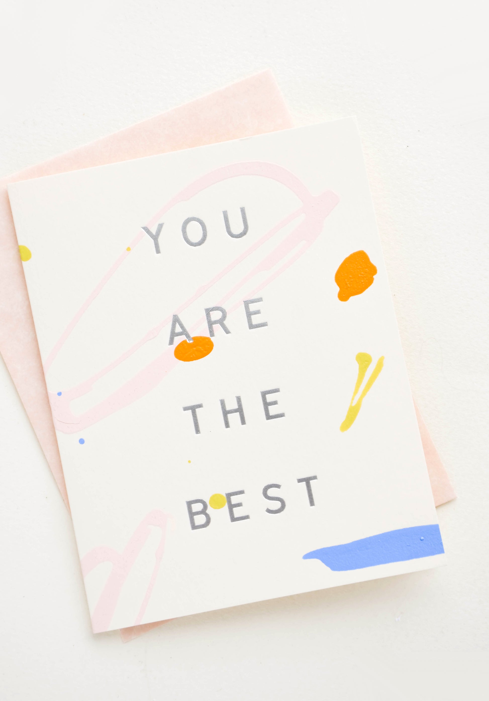 Greeting card with colored paint strokes and drips, silver lettering reads "You Are The Best"