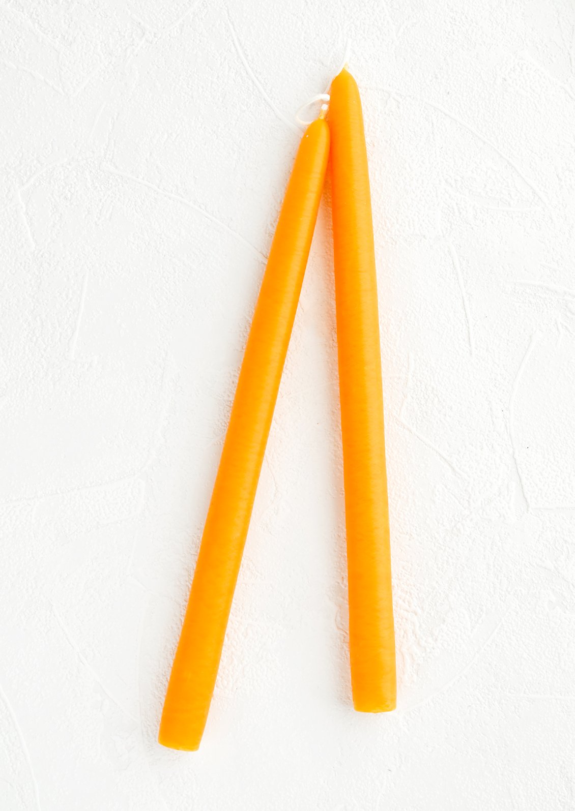 Pair of taper candles in passionfruit orange