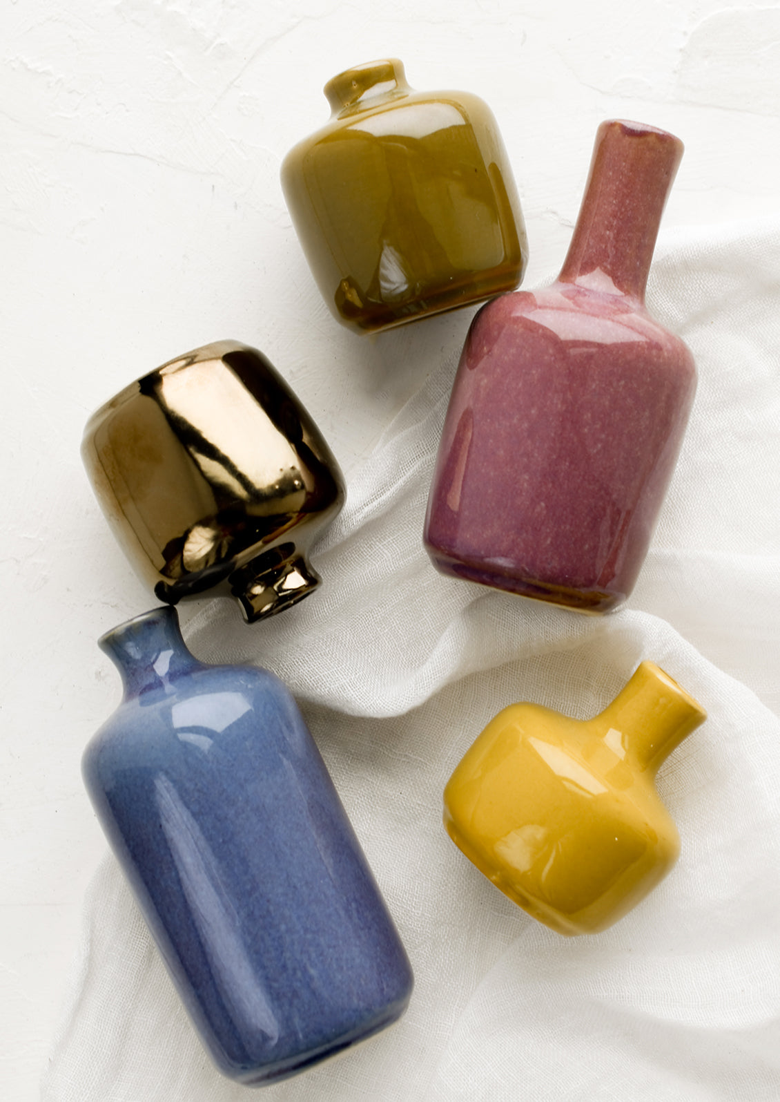Ceramic bud vases in assorted glaze colors.
