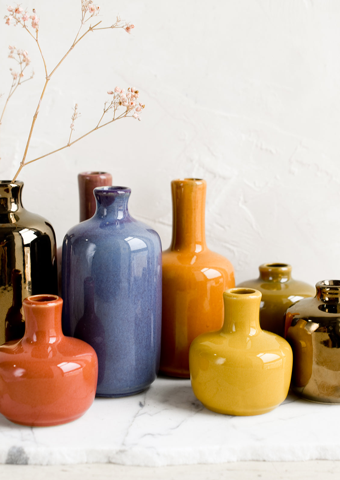 Ceramic bud vases in assorted glaze colors.