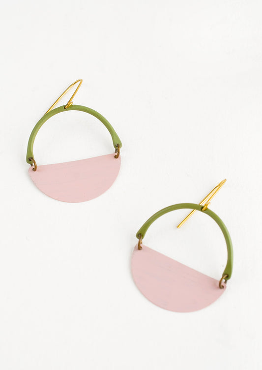 Earrings with olive arc shaped top and pink half moon shaped bottom with negative space in middle