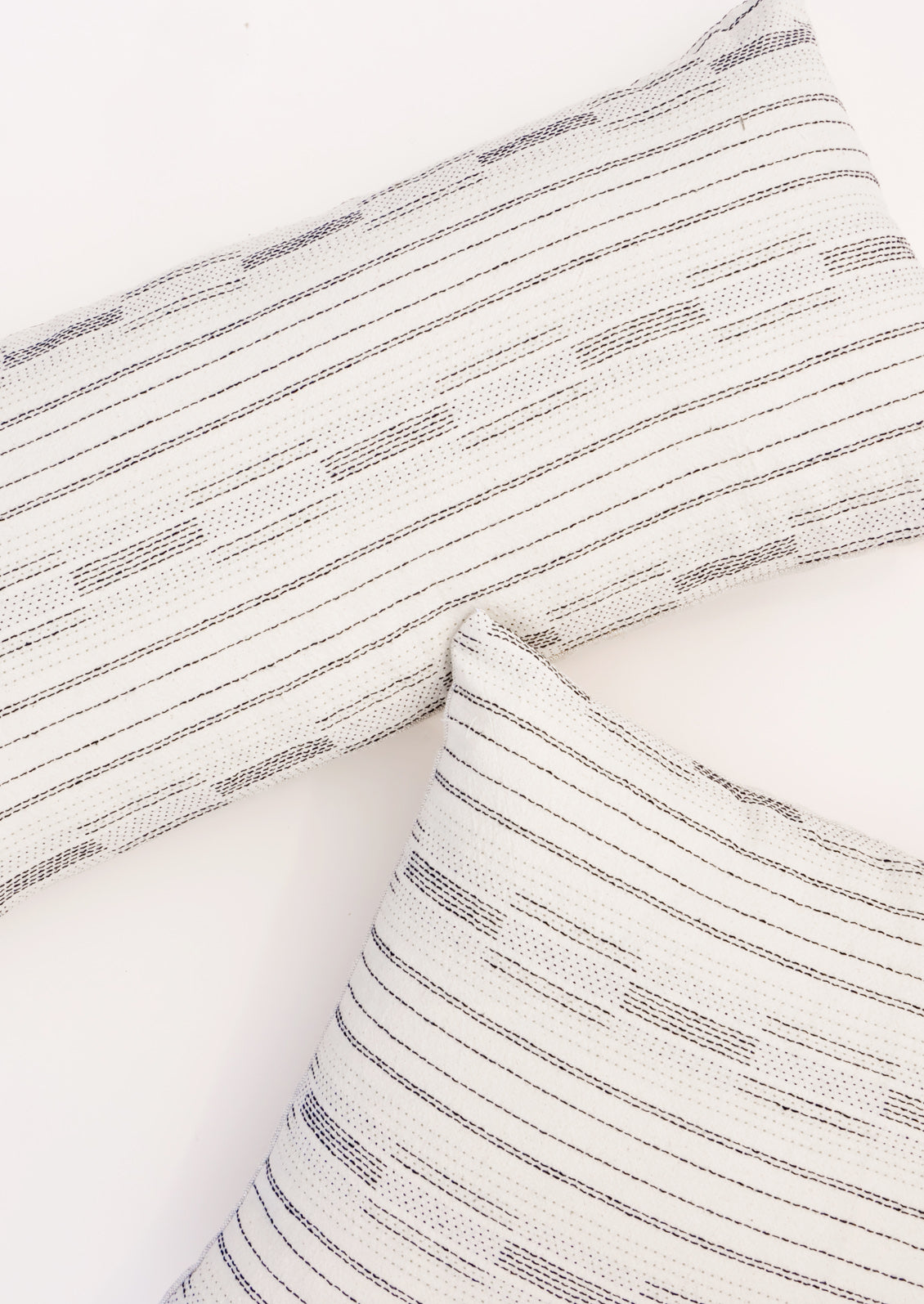 Pillows in square and lumbar sizes with black variegated stitching in assorted line patterns