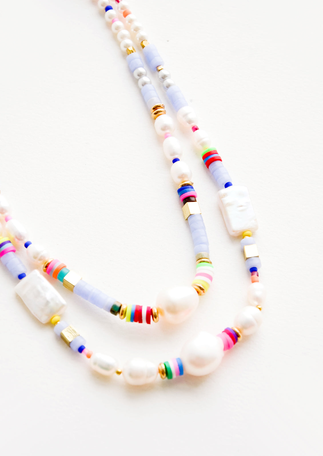 A mix of pearl, colorful plastic and gold metal beads on a double strand necklace