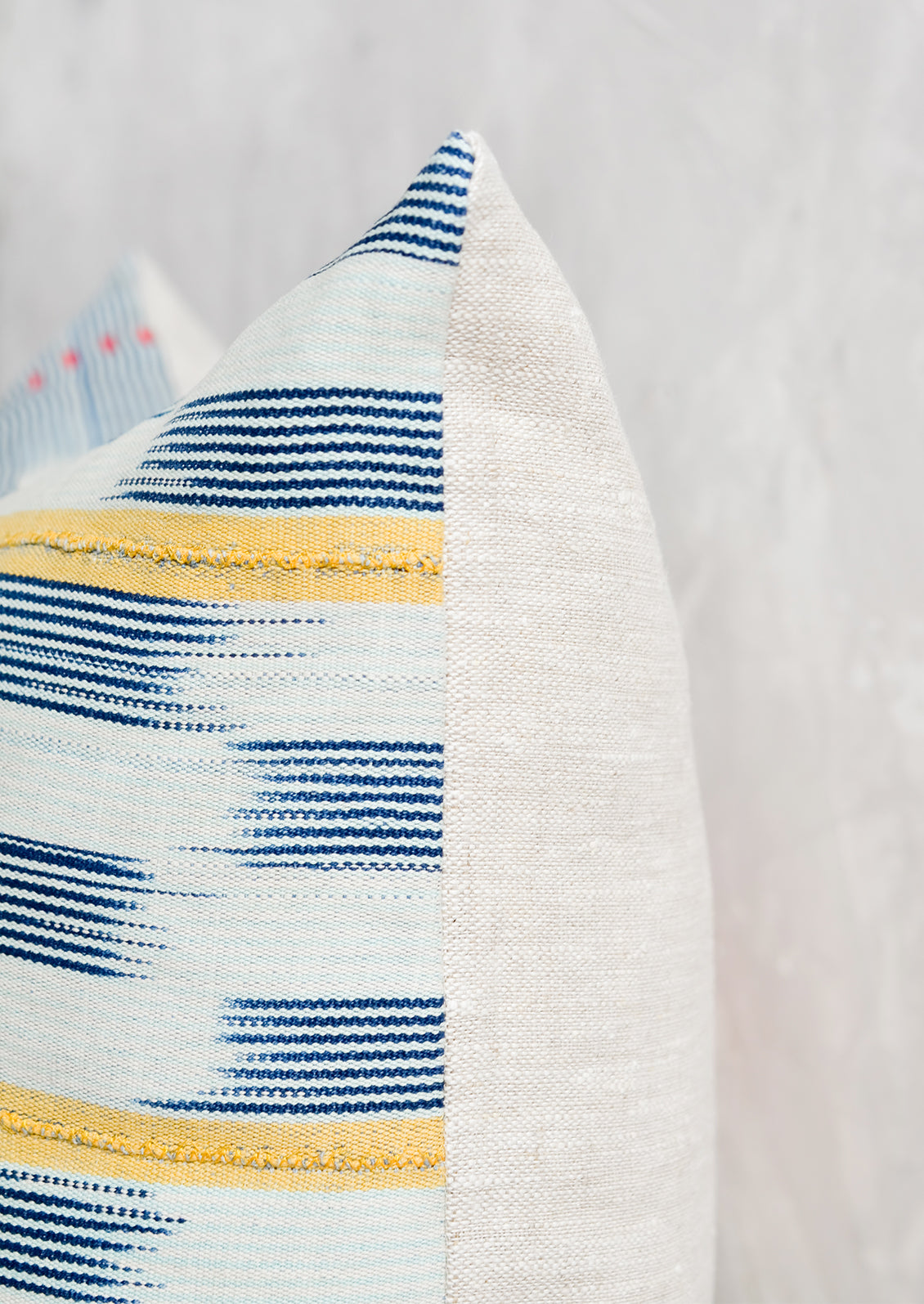 Throw pillow with plain linen backing.