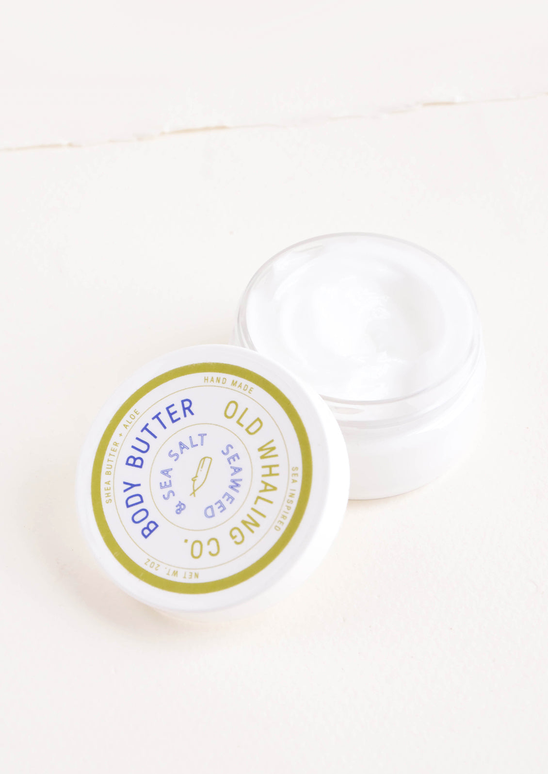 Round plastic jar of body/hand lotion in seaweed scent