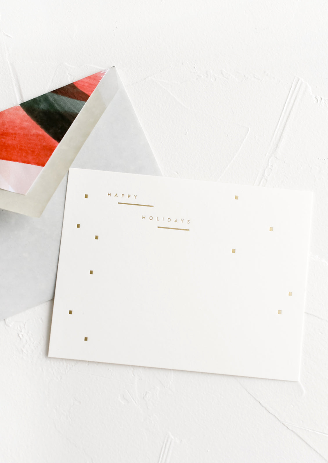 A set of holiday notecards with painted red and green envelope liners.