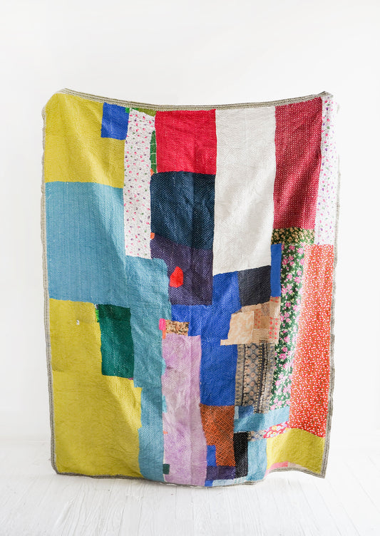 Vintage patchwork quilt in a colorful mix of fabrics. All different shades of green, blue, red & more.