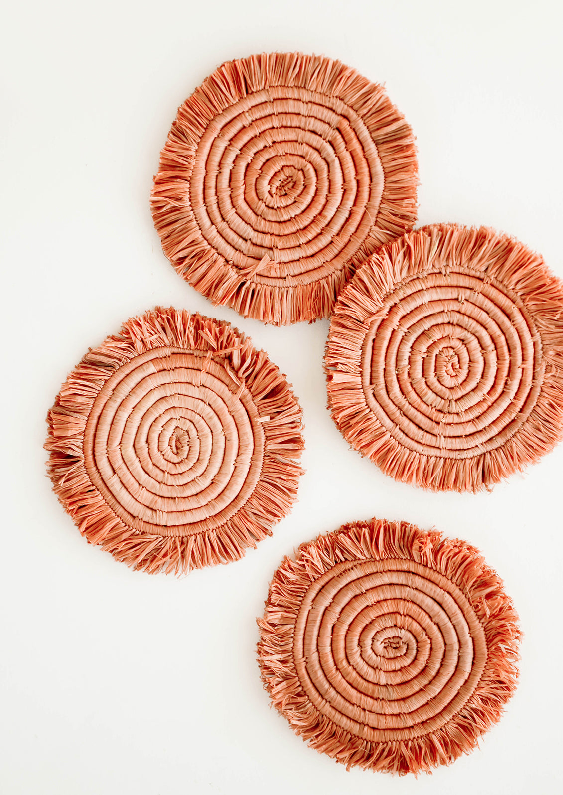 Set of 4 Circular Raffia Coasters with Fringed Trim in Dark Peach 