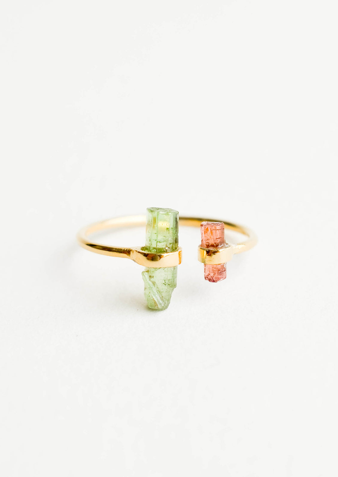 Adjustable yellow gold ring with opening at front, and pink and green tourmaline crystals at each side of opening.