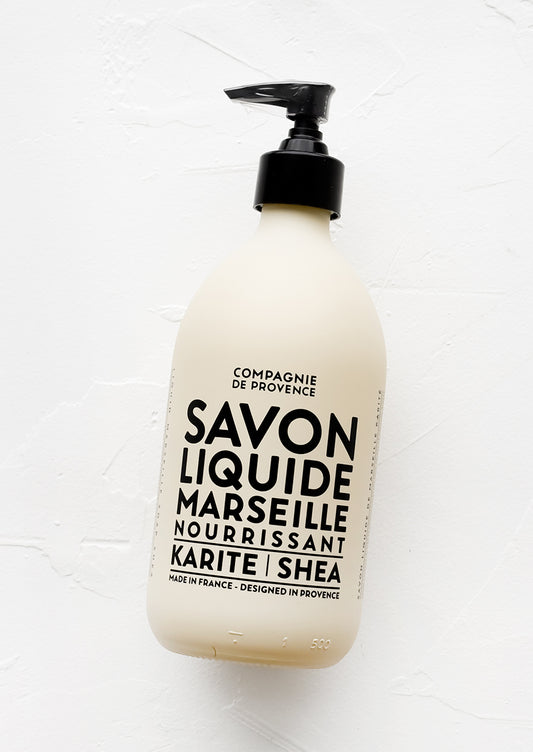 An opaque tan glass soap bottle with bold black text.