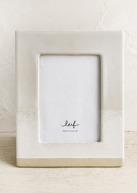 A ceramic picture frame in beige.