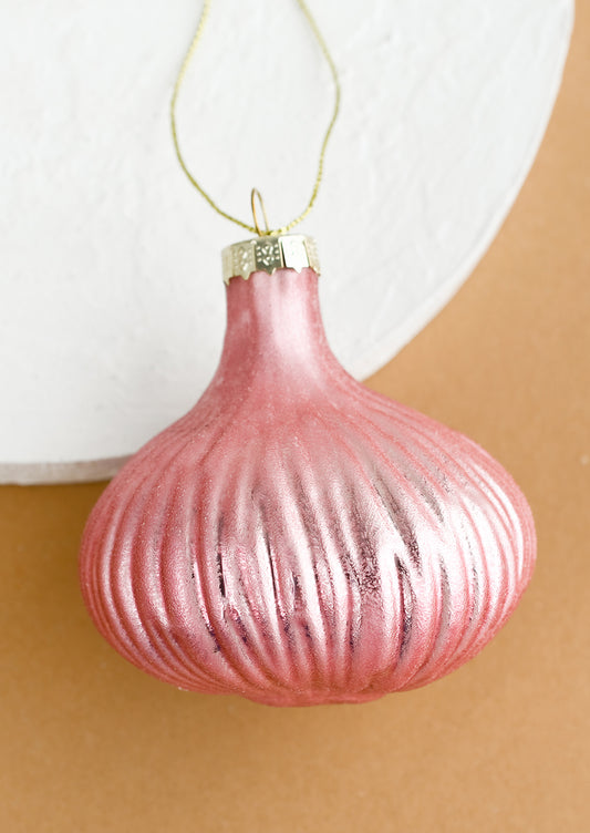 A glass ornament of a pink shallot onion.