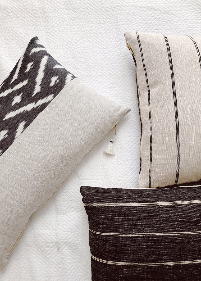 Black & White Pillows Casually Arranged on Bedsheets