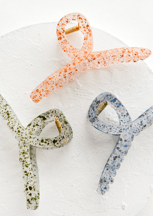 Three french twist style, speckled hair clips in assorted colors.