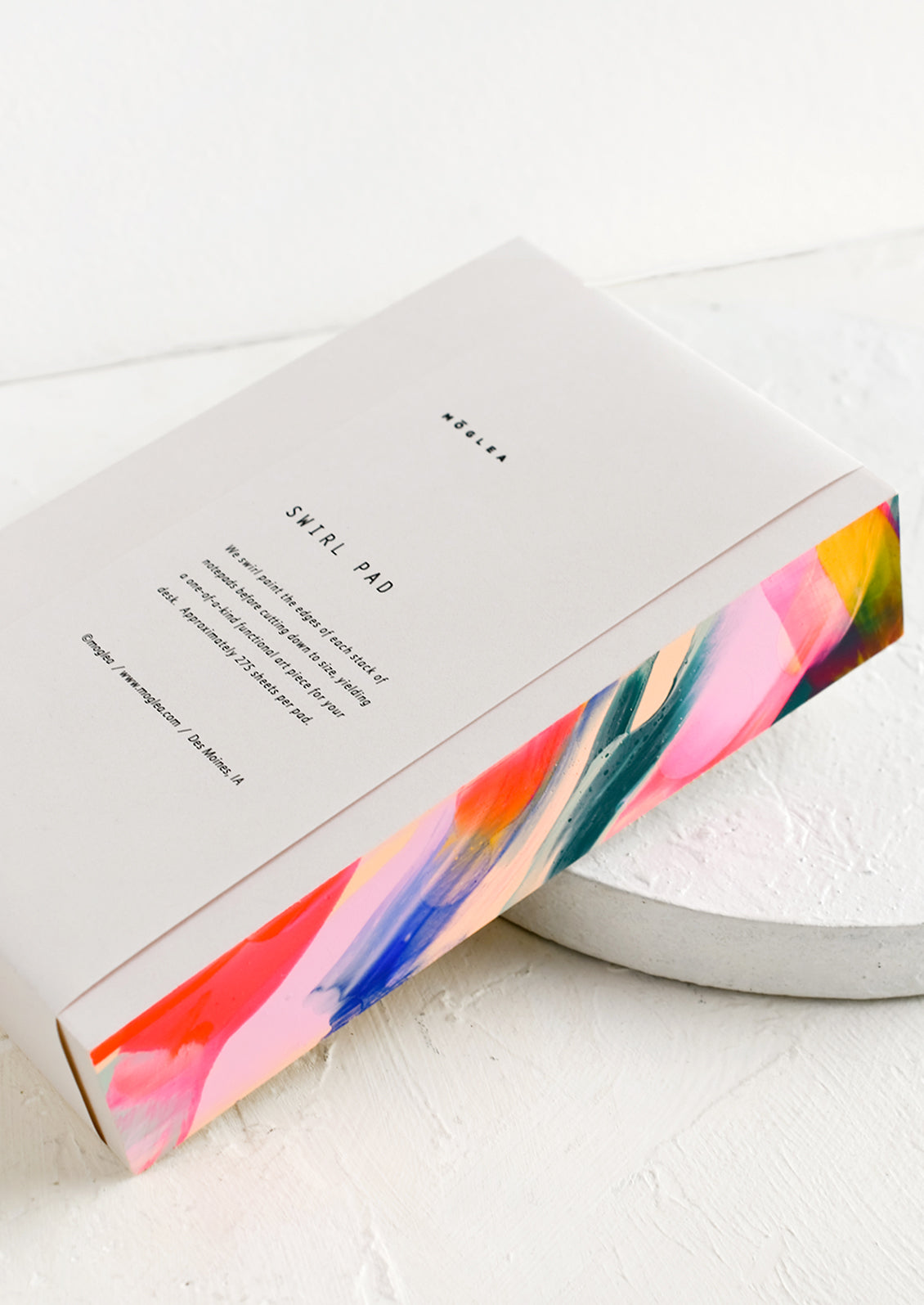 A chunky notepad with rainbow painted side