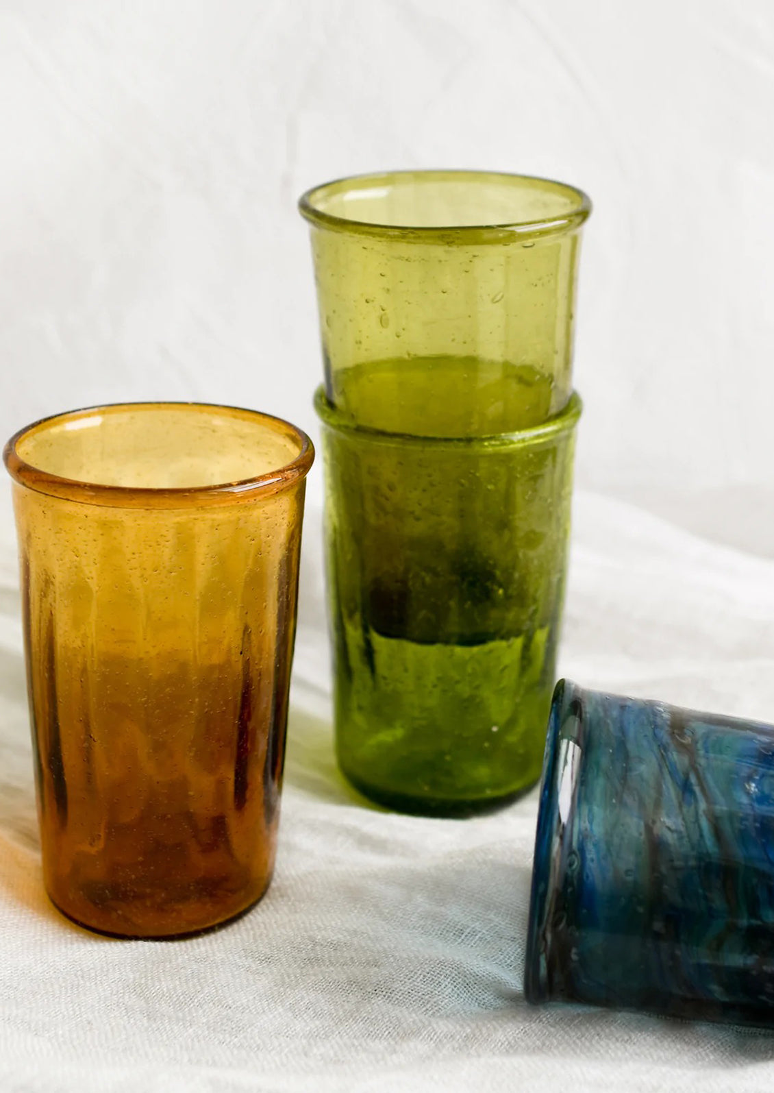 Colorful tumblers in translucent glass in assorted colors.