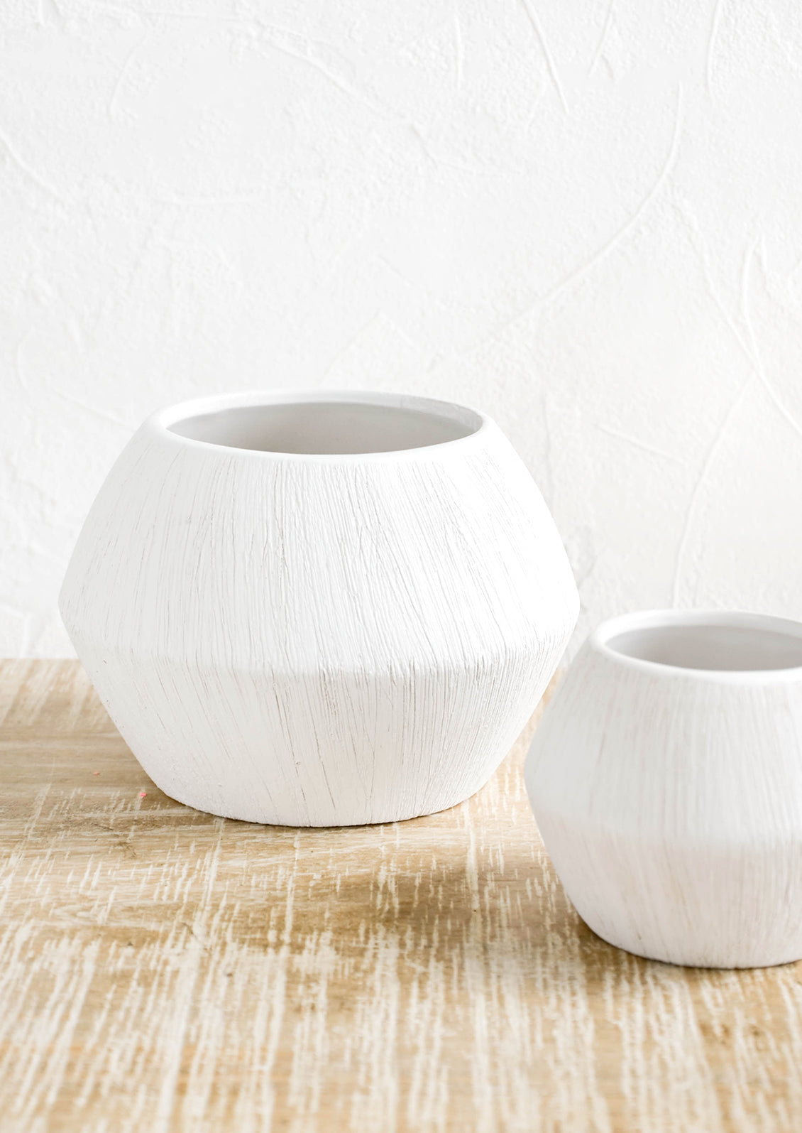 Textured white planters in small and large sizes. Plaster like appearance.