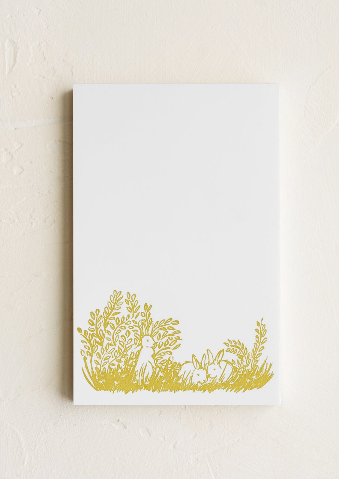 A letterpress printed notepad with bunny design at bottom.