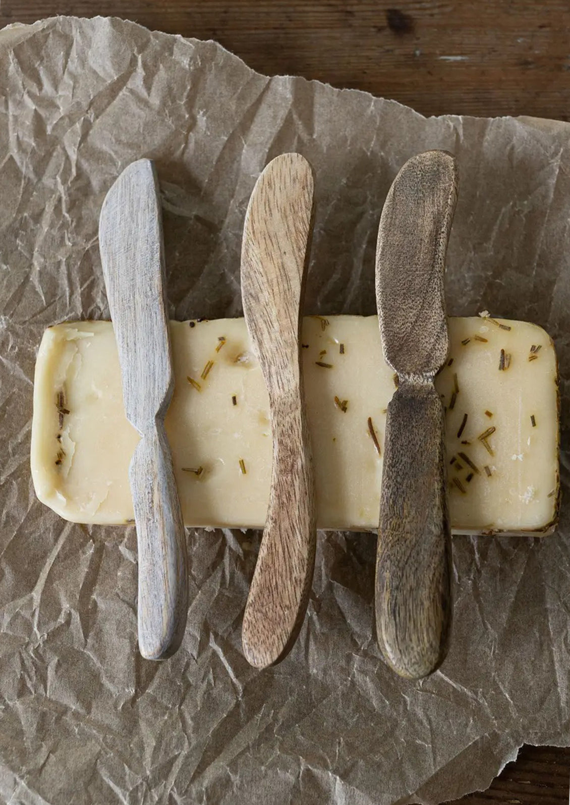 Wooden spreading knives in assorted wood tones.