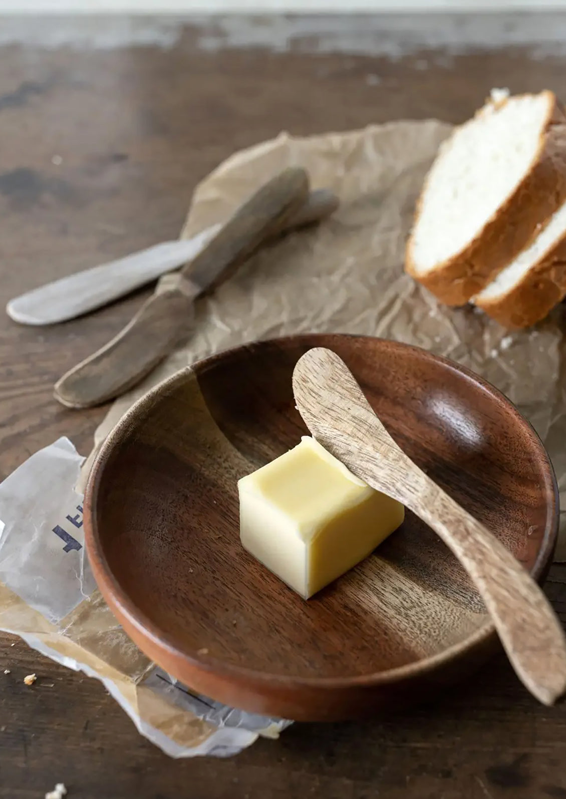 Wooden spreading knives in assorted wood tones.